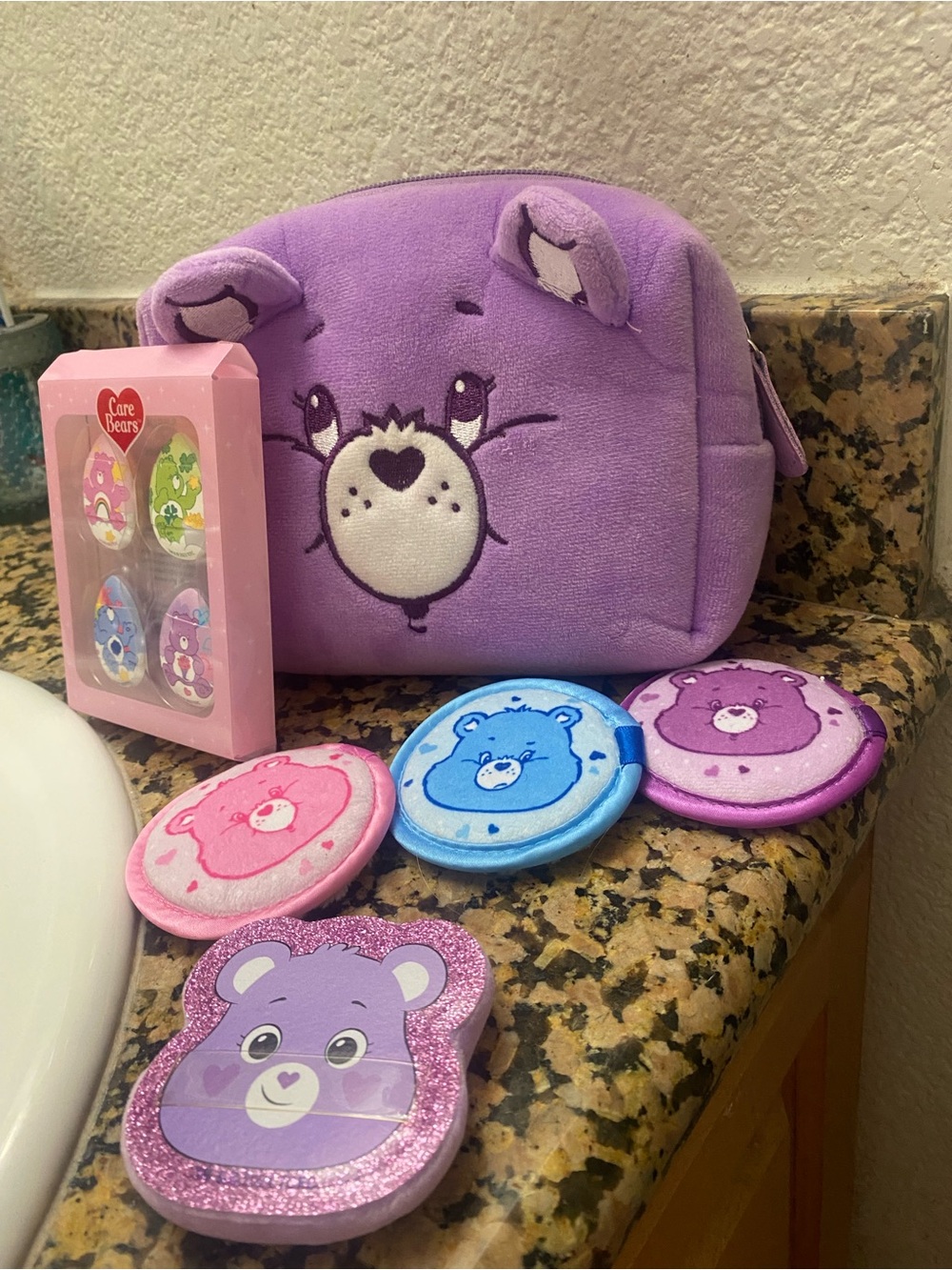 Carebear cosmetics bag with makeup accessories.